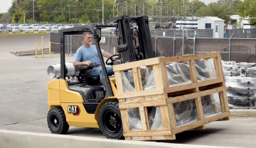 Operator Using a CAT IC Pneumatic Tire Lift Truck Outdoors